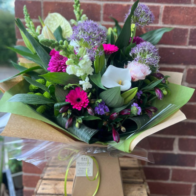 Violet Pop - A striking modern bouquet with pops of purple allium, white calla, hot pink gerbera, snapdragon, and lush green tones. Packed with texture and attitude.