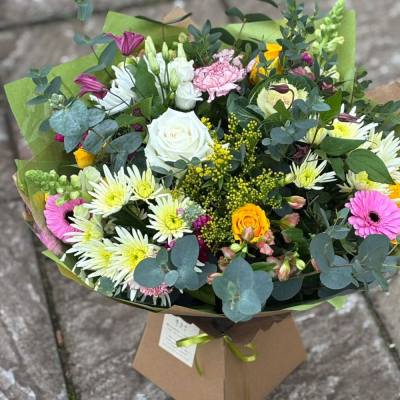 Happy Heart - A joyful burst of seasonal blooms in pinks, whites, and yellows with gerbera, roses, snapdragons, and lush eucalyptus. A perfect all-occasion pick-me-up.