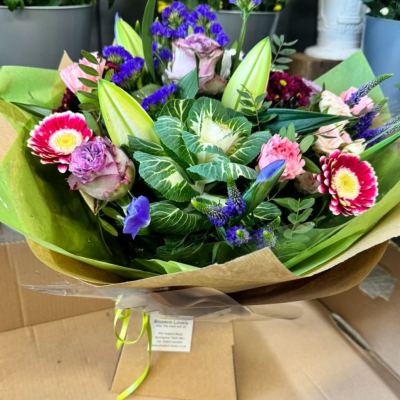 Berry Sorbet - Rich berry tones meet creamy blooms in this unique bouquet of bicolour gerbera, lilac roses, and foliage. A modern, moody mix full of personality.