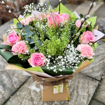Sweet Blush - A soft and graceful arrangement of pink roses, carnations, gypsophila, and willow accents. Delicately elegant for birthdays, thank-yous, or sympathy.
