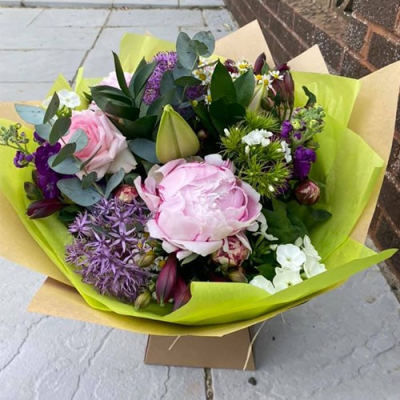 Secret Garden - A lovely handtied with seasonal flowers a mix of purple and pink, with complimentary foliage. Hand delivered Wellington and surrounding areas by Bloomin Lovely.