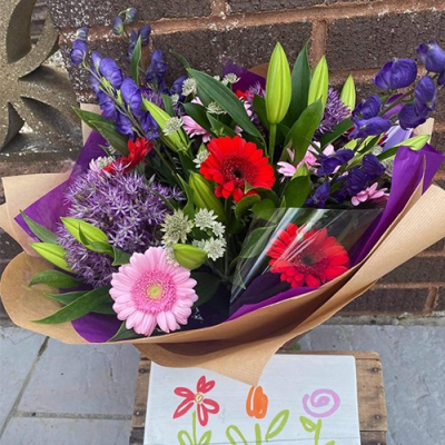 Perfect Blooms - A bright handtied with seasonal flowers a mix of purple,red and pink, with complimentary foliage. Hand delivered Wellington and surrounding areas by Bloomin Lovely.